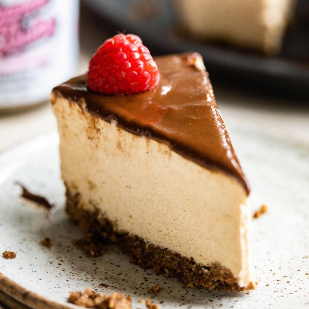 A dreamy, velvety smooth granola butter filling cheesecake. Top with either a raspberry or cherry! The perfect nut free dessert. 
