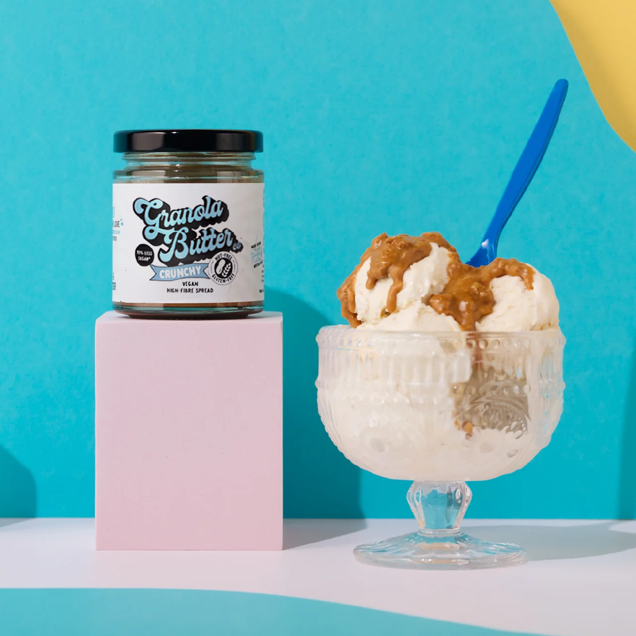 Jar of crunchy granola butter, the high fibre spread with a blue logo and nut free and gluten free icon visible on the recyclable packaging.  